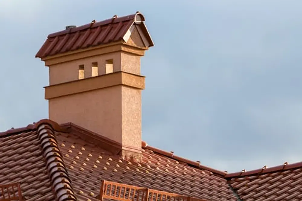 Masonry chimney with new flashing where it meets the roof surface