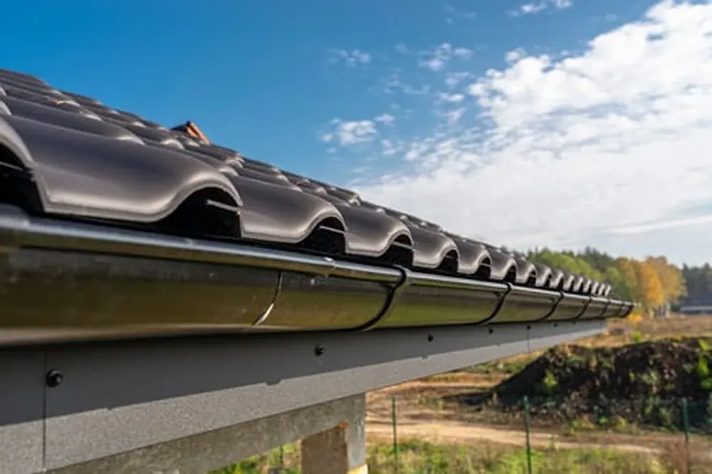 New seamless gutter run installed along a roof edge