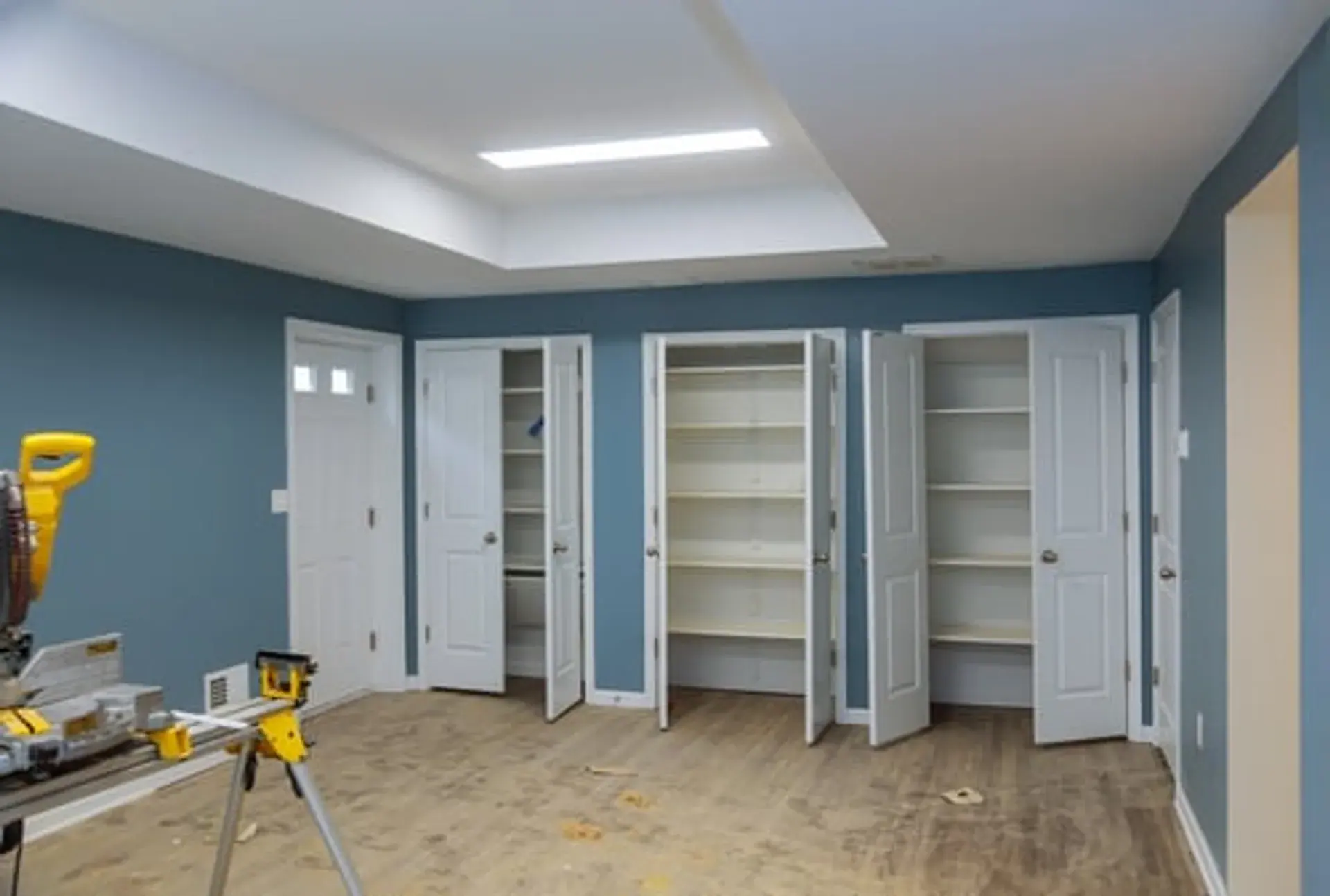 Interior of a home under renovation with fresh blue walls and new trim