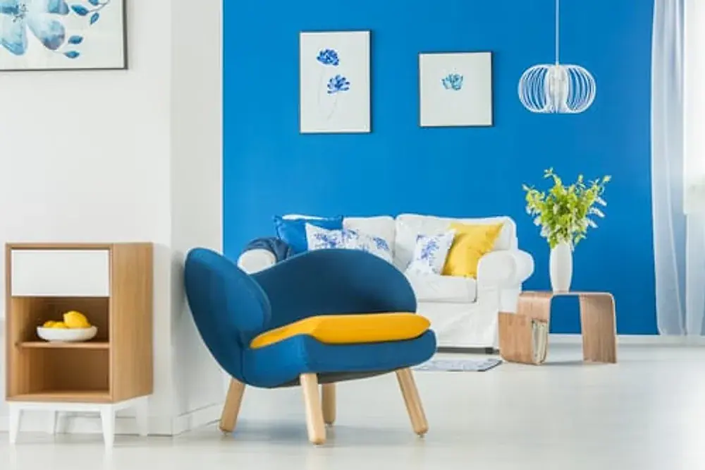 Living room with a freshly painted blue accent wall and white trim
