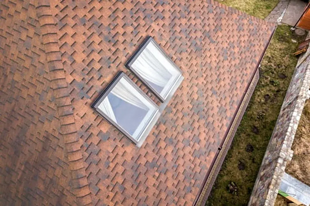 Roof with skylights installed and flashed into the shingle field