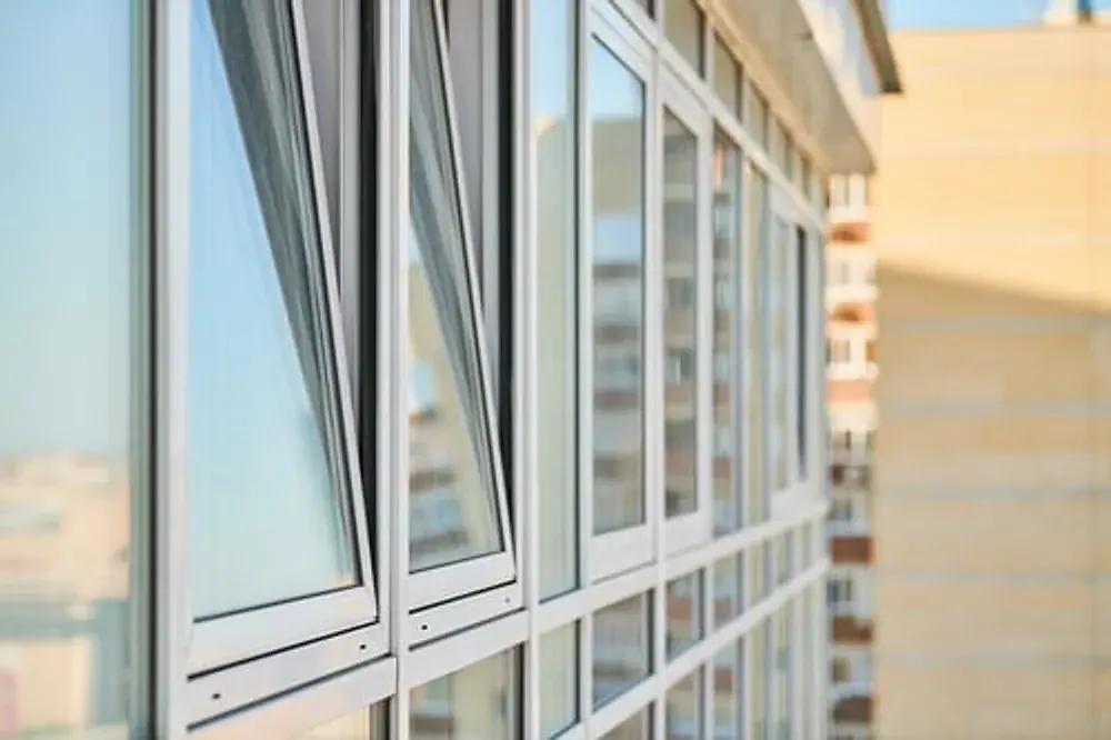 Modern replacement windows installed along a building facade